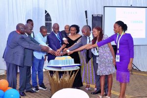 A team from the Advancement and Alumni Relations Unit, Members of Top Management, and the Chief Fundraiser cutting the cake.