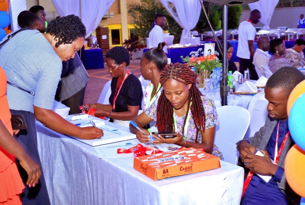 Attendees registering with the secretariat team on arrival at the entrance.
