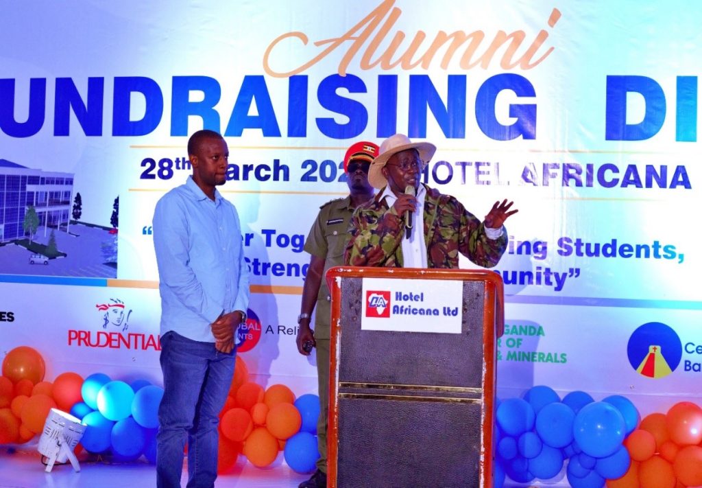 Chief Fundraiser, Eng. Buhanda Brian, invited to the stage by Tr. Mpamire during the alumni fundraising dinner at Hotel African.