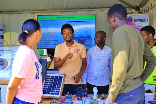 Mr. Baraka Harris joyfully sharing how energy is produced from his prototype 
