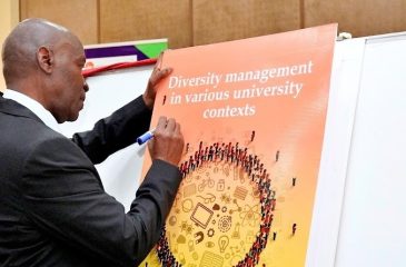 The Vice Chancellor Prof. Eli Katunguka signs on the launched book while Assoc. Prof. Kyazike the author looks on