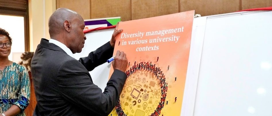 The Vice Chancellor Prof. Eli Katunguka signs on the launched book while Assoc. Prof. Kyazike the author looks on