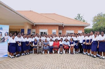 Staff of Kyambogo University pose for a photo with students of Bweranyange Girls during the Girls in STEM Day