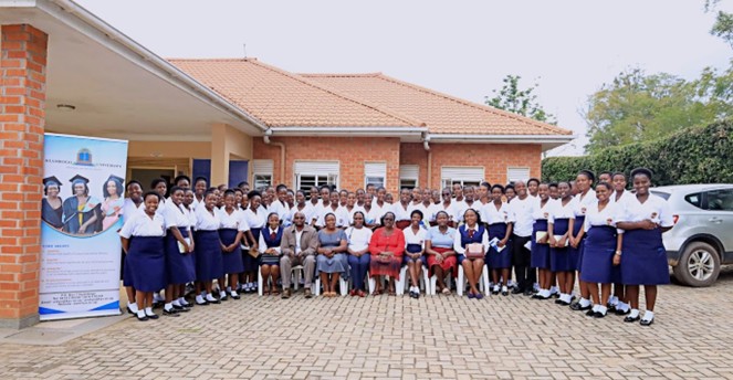Staff of Kyambogo University pose for a photo with students of Bweranyange Girls during the Girls in STEM Day
