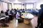 Academic staff attending a CBET workshop at Kyambogo University's IICD Conference Room, with a facilitator presenting to a full room of participants seated around tables.