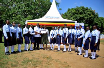 The Vice Chancellor Prof. Eli Katunguka handing over a certificate of recognition to one of the secondary schools present at the Girls in STEM event.